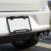 Close-up of a car's license plate frame with 'CAN-AM SPYDER' text on a blurred background.